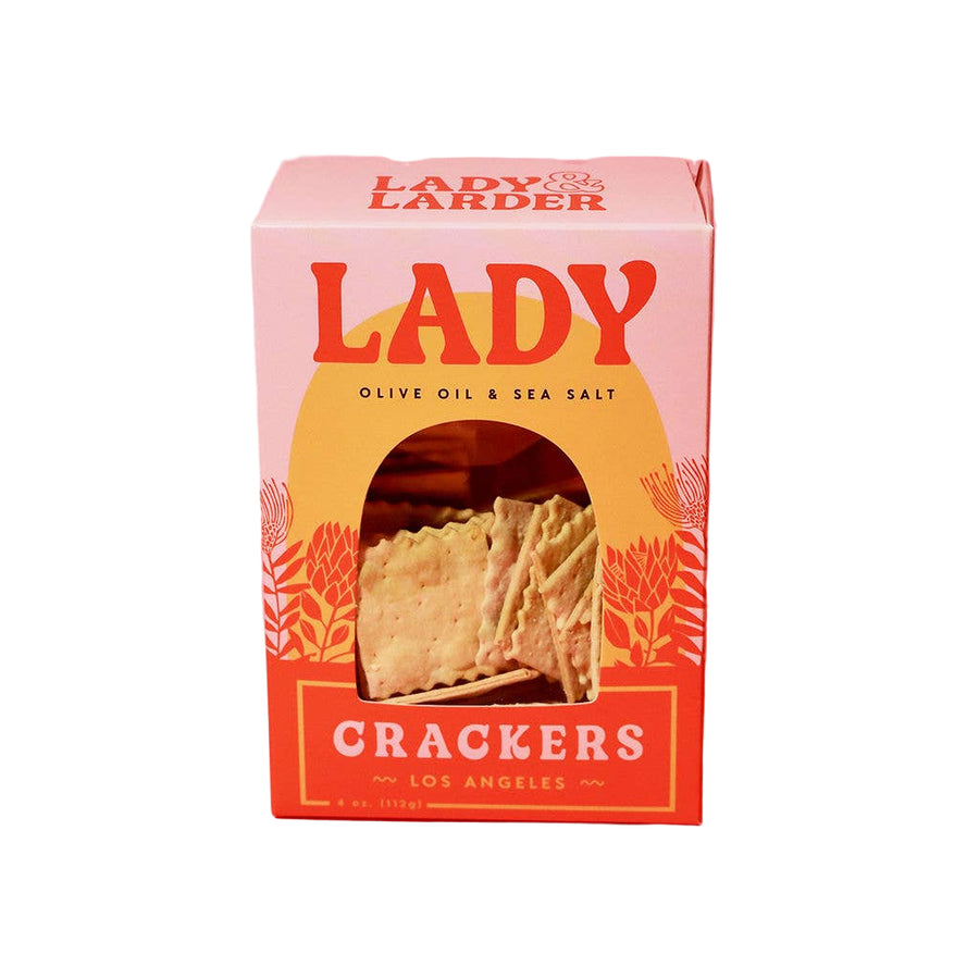 Box of Lady Crackers with 'Lady & Larder' branding on a pink background