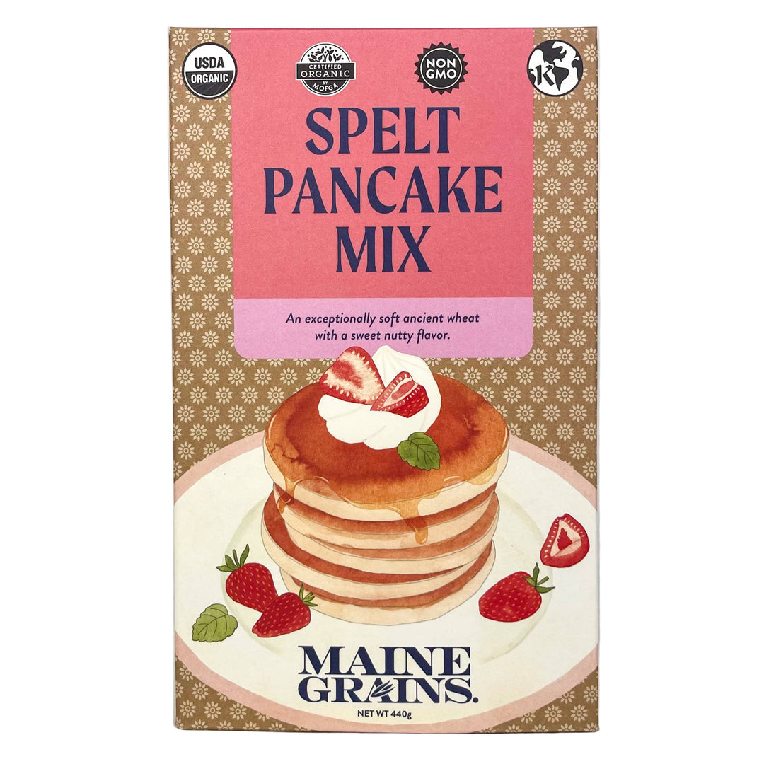 Package of Maine Grains Spelt Pancake Mix with an illustration of pancakes topped with strawberries and syrup on the front.