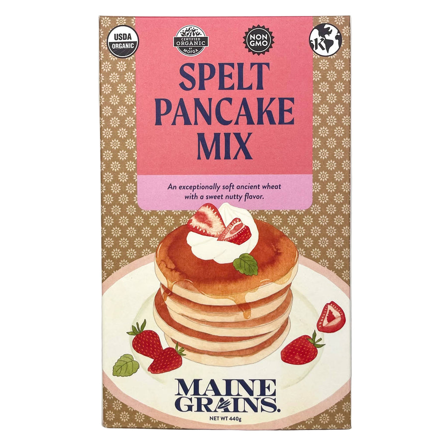 Package of Maine Grains Spelt Pancake Mix with an illustration of pancakes topped with strawberries and syrup on the front.